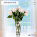 A clear glass vase with a flared rim and intricate sunburst patterns etched into its sides, against a white background.