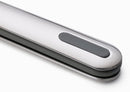 A stainless steel knife, fork, and spoon with black and silver handles, next to a translucent white rigid case. The handles are designed to fit together for compact storage.
