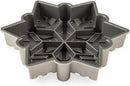 Nordic Ware cast aluminum snowflake-shaped baking pan with intricate detailing, shown on a white background.