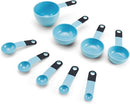 A set of nine light blue KitchenAid measuring cups and spoons with black soft-grip handles, spread out on a white surface. The set includes four cups and five spoons.