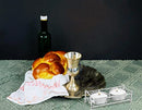 A boxed set featuring a shiny, rectangular, nickel-plated metal frame holder designed for two mini tealight candles, with two white tealights included.