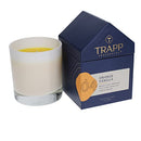 Trapp No. 4 Orange Vanilla 7 oz. House Box Candle in a frosted white glass container, placed next to its signature navy and orange house-shaped packaging.