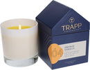 The Trapp No. 4 Orange Vanilla House Box Candle burning, creating a warm and inviting ambiance next to its stylish packaging.