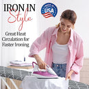 A person in a pink shirt uses a steam iron on a white garment on an ironing board, showcasing efficient ironing in a stylish setting.