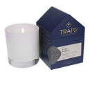 The Trapp No. 77 Palo Santo House Box Candle burning, creating a warm and inviting ambiance next to its elegant packaging.