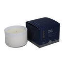 Trapp No. 77 Palo Santo 3.75 oz. Small Poured Candle in a sleek white glass container, placed next to its navy and gray packaging.
