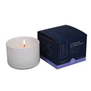 The Trapp No. 25 Lavender de Provence 3.75 oz candle burning next to its packaging, creating a warm and soothing ambiance.