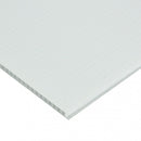 Close-up view of a white corrugated plastic sheet, showing the textured ridges and hollow fluted core.