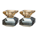 Pair of elegant crystal candlesticks with gold-toned tops and faceted bases