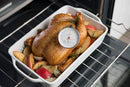 Taylor brand classic style meat thermometer featuring a round dial with Fahrenheit markings from 120 to 200 degrees. The dial face includes icons for beef, pork, poultry, and lamb/veal, along with recommended temperatures for different levels of doneness. The thermometer has a stainless steel probe and a clip for oven use.