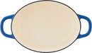 Blue enameled 7-quart cast iron Dutch oven on a white background.