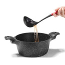 A versatile black nylon ladle by Starfrit, featuring a built-in skimmer function for easy separation of solids from liquids.
