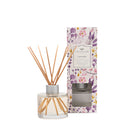 4oz lavender reed diffuser in a clear glass bottle with fiber reeds on a white background.