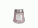 A small, clear glass jar candle with a soft purple/lilac colored wax. It has a silver metal lid and a decorative label featuring the scent 'Lavender.'
