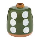 A small, squat stoneware bud vase with a dark green speckled glaze, featuring a hand-painted white dot pattern resembling dice, and an exposed terracotta base.