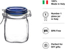 A clear, empty Bormioli Rocco Fido square glass jar with a dark blue hinged lid and wire bail closure, featuring an airtight rubber gasket.