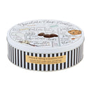 A large, themed gift set including a white tin printed with a chocolate chip cookie recipe, two cookies tied with a red bow, a blue can of Bartenura Moscato, and a small gold mask.
