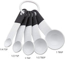 White plastic measuring spoon set with black accents and organizing ring