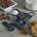 Five Black KitchenAid measuring spoon set including 1 tbsp, 1 tsp, 1/2 tsp, 1/4 tsp, and 1/8 tsp sizes.