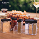 Clear plastic Farberware BBQ Slim Spice Set featuring six labeled compartments containing cumin (ground), granulated garlic, chopped onion, paprika (ground), ground black pepper, and fine sea salt, all neatly organized in a slim, clear holder with black lids.