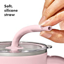 A tall, matte pink OXO Strive XL tumbler with a clear lid, a pink straw inserted, and a sturdy pink handle on the side. The gray OXO logo is visible on the tumbler's body.