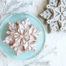 snowflake-shaped cake on a light blue plate