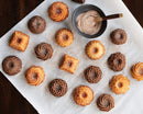 mini bundt cakes with cinnamon sugar, on a cake sheet, on a wooden table