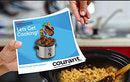 Stainless steel slow cooker with black lid and control dial.