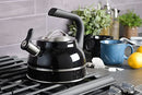 A black Kenmore Elite Costner whistling tea kettle with a polished stainless steel band at its base and a heat-resistant black Bakelite handle.