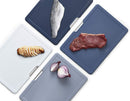 Large Folio plastic cutting board set with four color-coded boards in a slimline case, displayed on a white background.