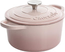 Blush pink cast iron Dutch oven with lid.