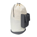 Large beige canvas laundry bag with a gray base and zippered side pocket.