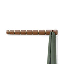 Walnut and black Umbra Flip 8-Hook wall-mounted coat rack with retractable hooks on a white background.