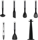A set of six gray and black Joseph Joseph kitchen utensils on a black rotating carousel stand. The utensils include a spoon, ladle, spatula, and tongs.