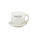 A white ceramic shaker set shaped like a miniature teacup and saucer. The cup features vertical ribbing and the black text 'Shake it off' on the side.