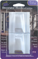 A package of two white, square plastic decorator hooks. The packaging is labeled "Magic Mounts Decorator Hooks self-sticking" and states that they "HOLDS UP TO 5 LBS." The background image shows the hooks on a porch setting.