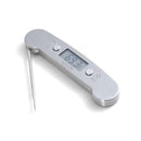 Angled view of the Taylor digital meat thermometer with folding stainless-steel probe and digital display, shown open on a white background.