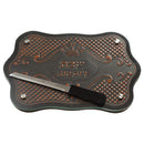 Art Judaica wooden challah board with engraved Hebrew and a serrated bread knife.