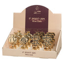 Assorted gold-toned wine corks with traditional Jewish designs including pomegranates and the 'Borei Pri HaGafen' blessing.