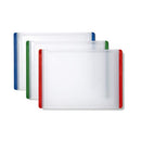 A set of three OXO cutting boards in different sizes, each featuring a translucent white cutting area and colored non-slip edges in blue, green, and red for stability.