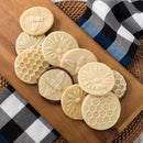 honeybee-themed cookies arranged on a wooden serving tray, on a table