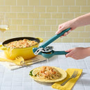 A side view of a teal-colored Chef'n FreshForce Lemon Squeezer, showcasing its ergonomic design with two long handles, and visible chrome-plated metal components at the hinge and pressing mechanism.