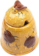 A whimsical ceramic honey pot designed like a yellow beehive with textured walls, featuring two dark brown bees on its exterior and a fitted lid with a small bee on top.