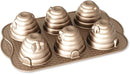 Toffee-colored Nordic Ware Beehive Cakelet Pan with six mini beehive cavities, displayed on a white background.
