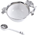 A two-piece serving set featuring a small, round white porcelain bowl with an ornate silver metal pomegranate-shaped trim, and a matching white and silver serving spoon.