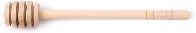 Wooden honey dipper with grooved head and brown finish on a white background.