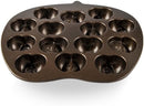A bronze-colored cast aluminum baking pan with six cavities molded into various autumn shapes, including pumpkins, acorns, and oak leaves.