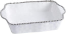 A rectangular, white porcelain baking dish with a dimpled texture and a silver beaded rim.