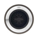 OXO sink accessory with a black center that can function as a strainer or a stopper, surrounded by a stainless steel ring and a gray silicone outer edge.