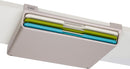 A slim Joseph Joseph Folio cutting board set in a gray storage case. Three color-coded cutting boards—blue, green, and white—are stacked inside the case.